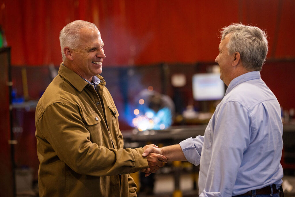 Image of Joe Emrick speaking with a constituent at a shop